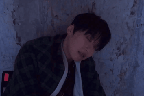 a young man is sleeping with a zzz written on his head