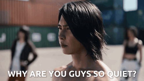 a man without a shirt is standing in front of a group of people and the caption says why are you guys so quiet