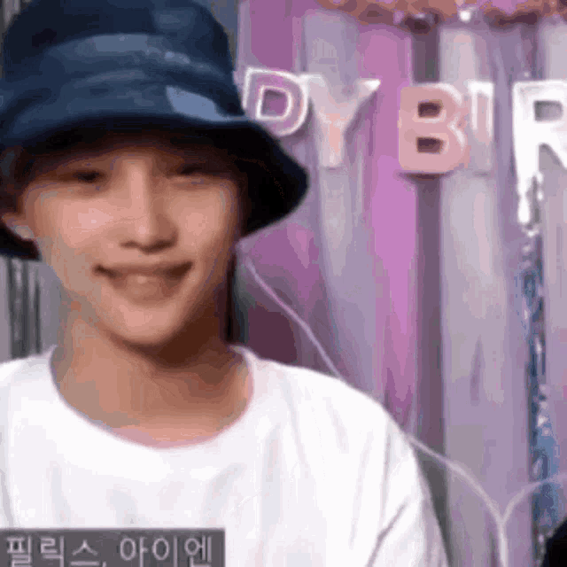 Felix smiles in a bucket hat during a vertical live-video clip.