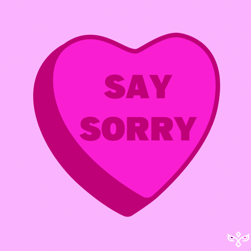 a pink heart shaped candy says say sorry