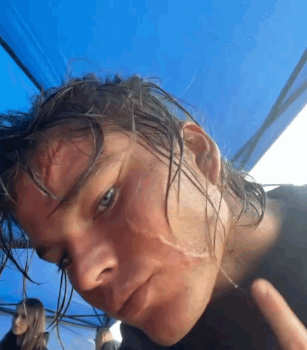a close up of a person 's face with wet hair