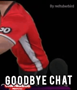 a man in a red shirt is sitting in front of a microphone with the words `` goodbye chat '' written on it .