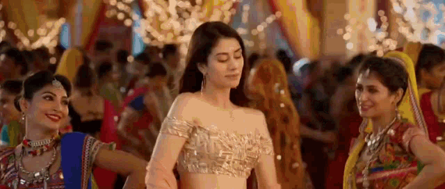 a woman is dancing in front of a crowd of people at a wedding reception .