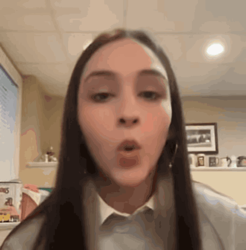 A woman forms an “O” with her mouth in surprise.
