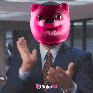 a man in a suit and tie with a pink bear mask on his face