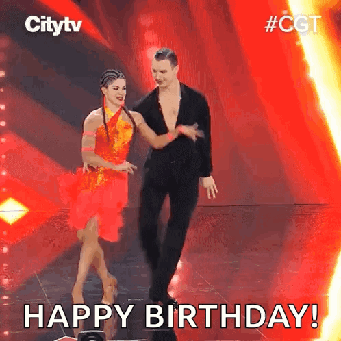Two ballroom dancers perform on a red-lit television stage with “HAPPY BIRTHDAY!” text.