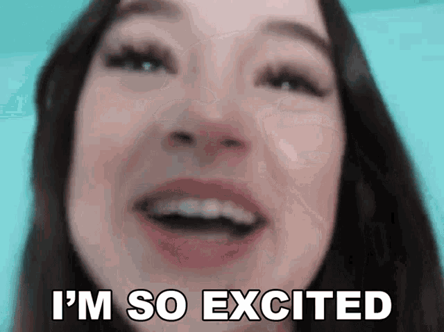 a close up of a woman 's face with the words `` i 'm so excited '' written on her face .