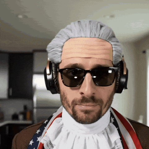 a man wearing a wig and sunglasses has headphones on his head