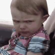A child frowns intensely with an angry, narrowed stare.