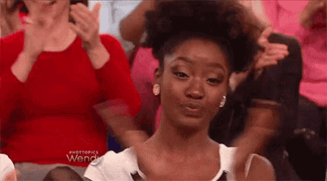 Wendy Williams gives a measured clap from her talk-show seat.