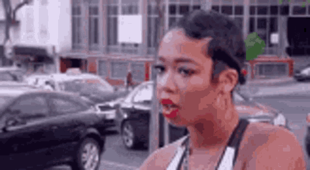 A woman shakes her head outdoors in a clip captioned “DUH”.