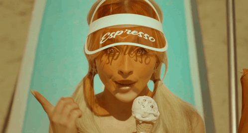 a woman wearing a visor that says presso on it