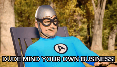 a man in a blue superhero costume is sitting in a chair and says dude mind your own business