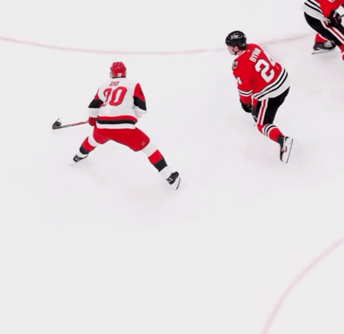 a hockey player with the number 30 on his back is skating on the ice