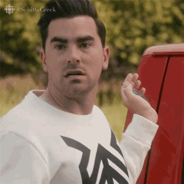 David Rose from Schitt’s Creek turns around with a shocked angry look.