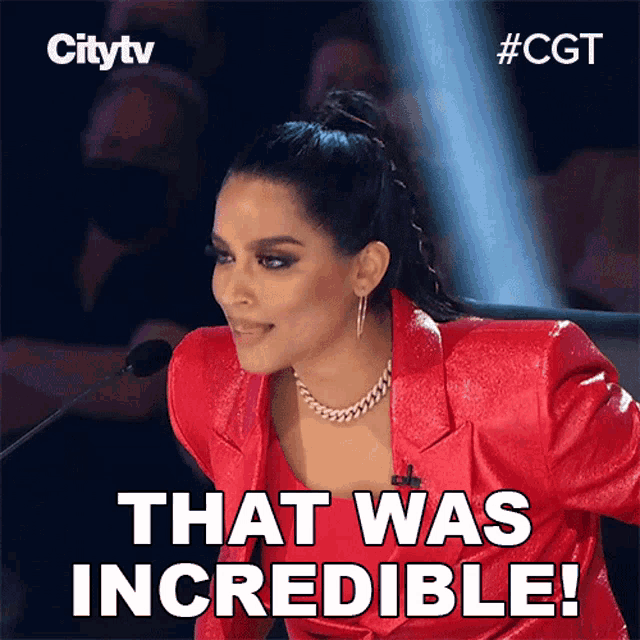 a woman in a red jacket stands in front of a microphone with the words that was incredible written below her