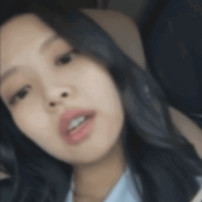 a close up of a woman 's face with a blurry background .