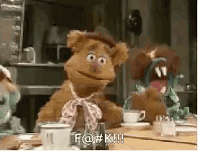 Fozzie Bear reacts wildly at a table with the caption “F@#K!!!”