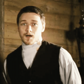 a man wearing a vest and a white shirt is making a surprised face