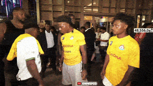 a man wearing a yellow shirt that says ethiopia on it