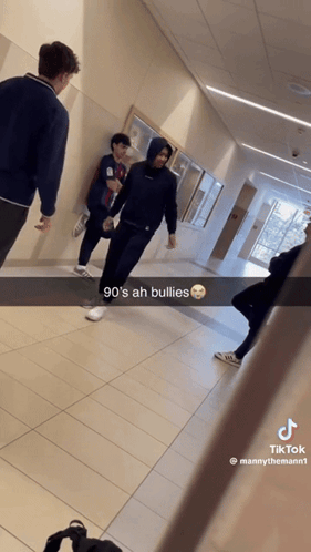 a group of people walking down a hallway with the caption 90 's ah bullies on it