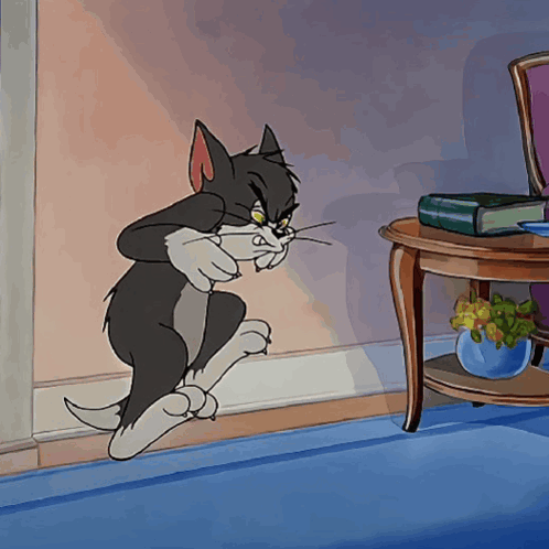 Tom from Tom and Jerry looks startled with multiple enlarged eyes.