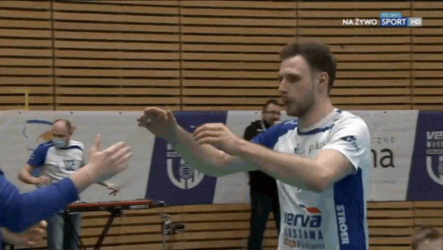 a man wearing a blue and white jersey with the word verva on the side