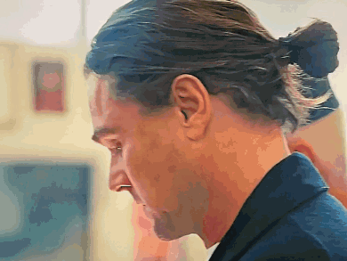 a man with long hair in a ponytail