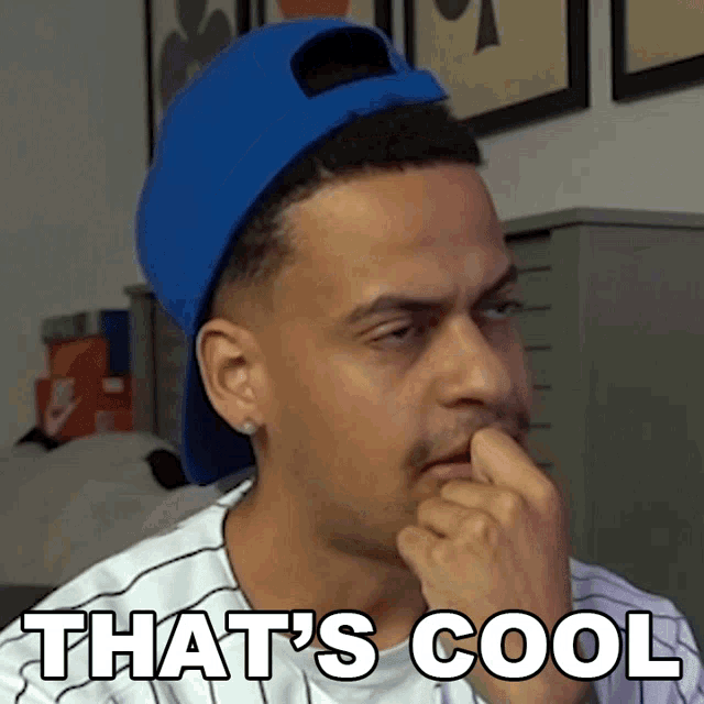 a man wearing a blue hat and a white shirt with the words that 's cool