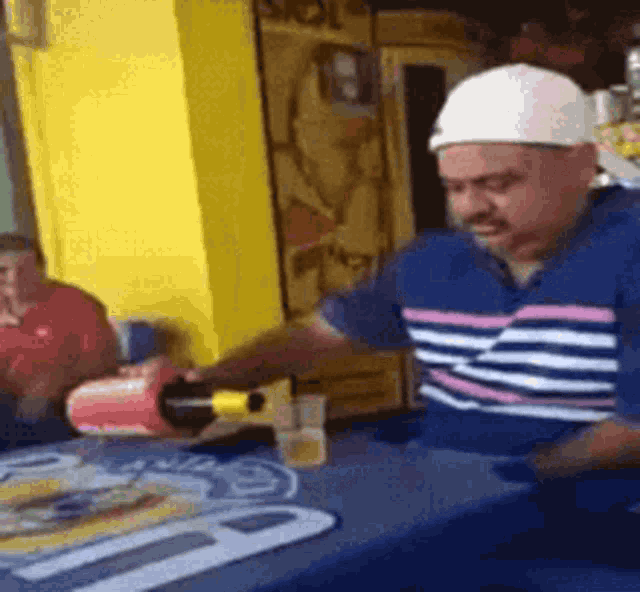 a man is pouring a bottle of beer into a glass .