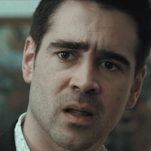 A man stares ahead with a disturbed, confused expression.
