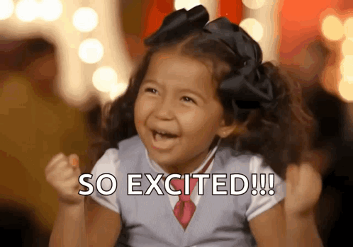 A smiling young girl pumps her fists beneath the caption “SO EXCITED!!!”.