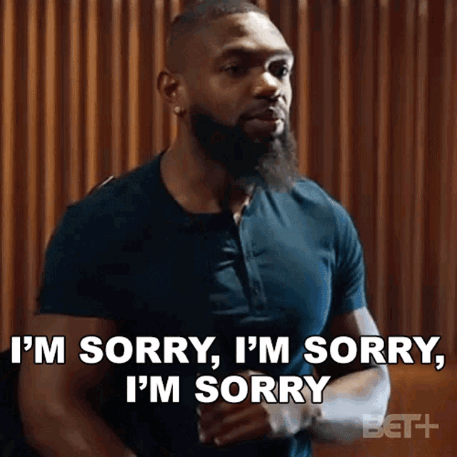 a man with a beard is saying i 'm sorry , i 'm sorry i 'm sorry