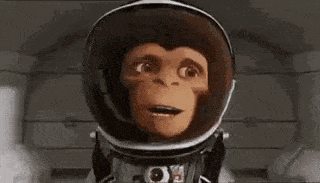 a cartoon monkey is wearing a space suit and screaming with his mouth open .