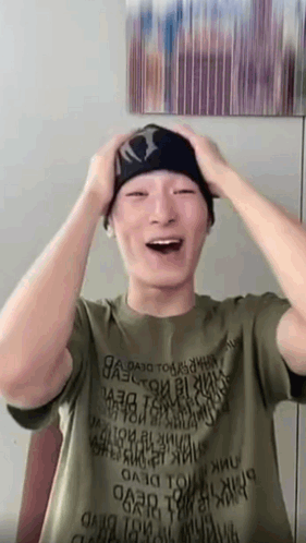 A person raises both hands to their head in an excited shocked reaction.