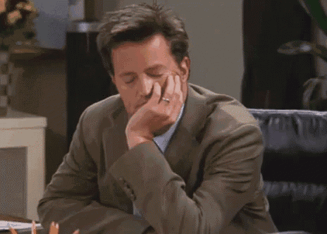 A man rubs his face with a tired *(YAWN)* caption.