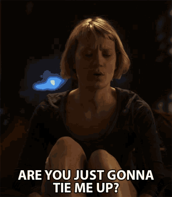 a woman sits on a couch and says " are you just gonna tie me up ? "