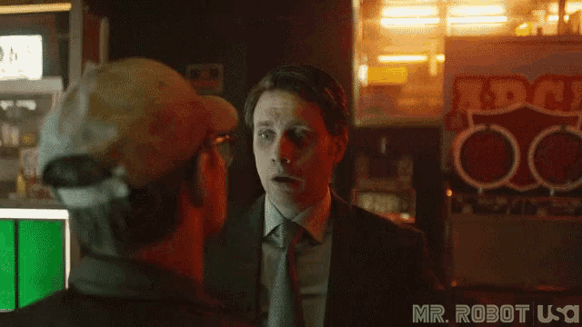 a woman in a dark room with a sign that says mr. robot usa