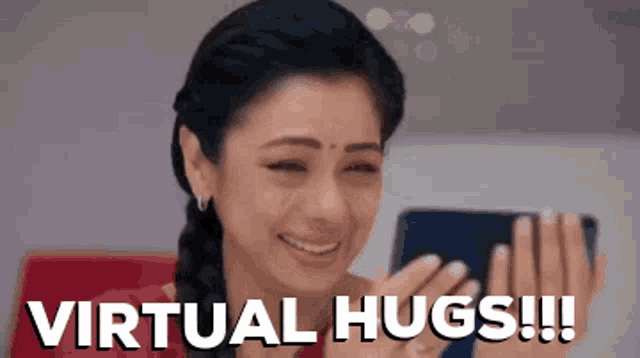 a woman is crying while looking at a cell phone with the words virtual hugs !!! written below her