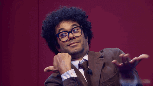 a man wearing glasses and a suit says what ya gonna do
