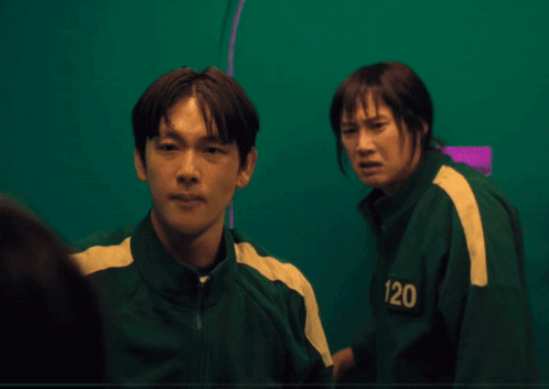 a man and a woman are standing next to each other and the man is wearing a jacket that says 120