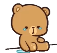 A small brown cartoon bear cries beside a broken heart.