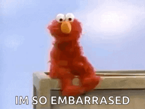 Elmo sits awkwardly on a ledge beneath “I’M SO EMBARRASED.”