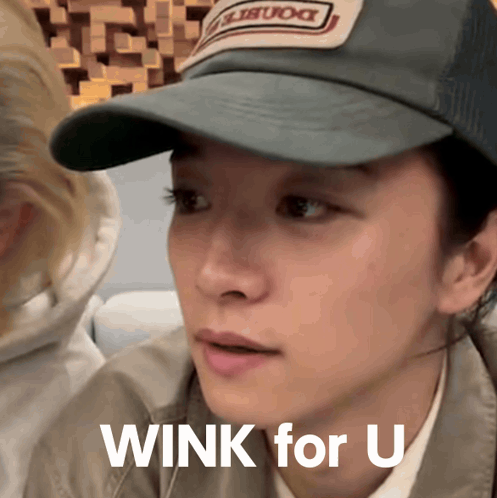 Mizuki wears a cap and looks sideways with “WINK for U” text.