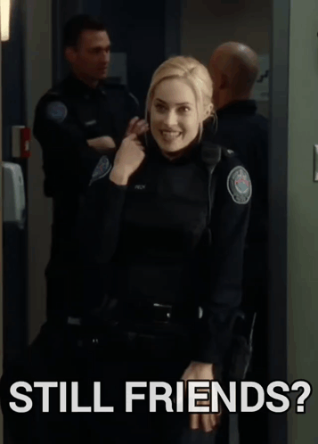 a woman in a police uniform is standing next to a sign that says still friends ?