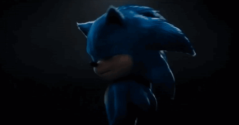Sonic the Hedgehog stands in the dark with his head lowered.