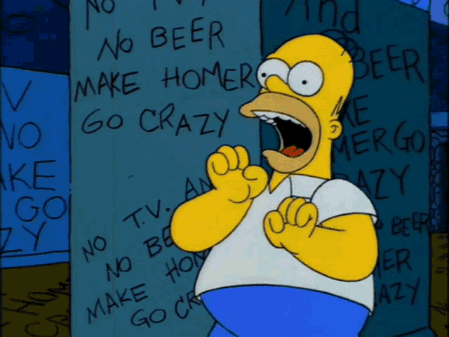 Homer Simpson grins manically in a room covered in writing.