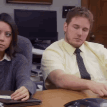An office worker looks bored during a meeting after lunch.