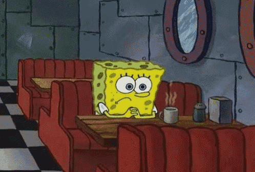 SpongeBob sits alone in a row of empty movie-theater seats.