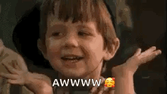 A child smiles and shrugs with “AWWW” and a blushing emoji.